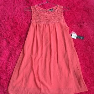 Peach dress with Designs on the Top Quarter